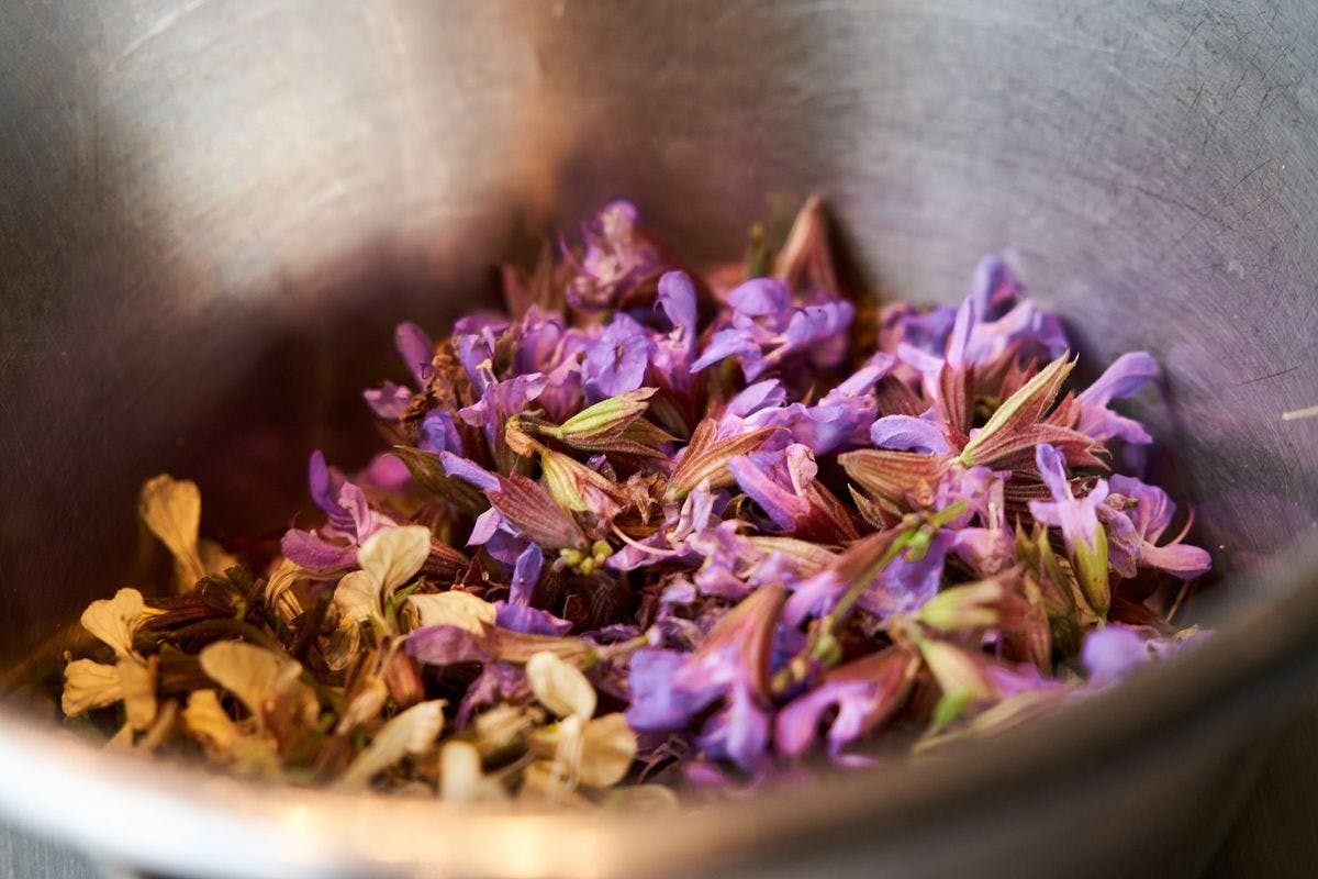 Close-up of dried flowers in a pot used for cooking and spice blending. The image shows the detailed flowers and pot as part of the culinary preparations at Mogens Dahl Concert Hall.