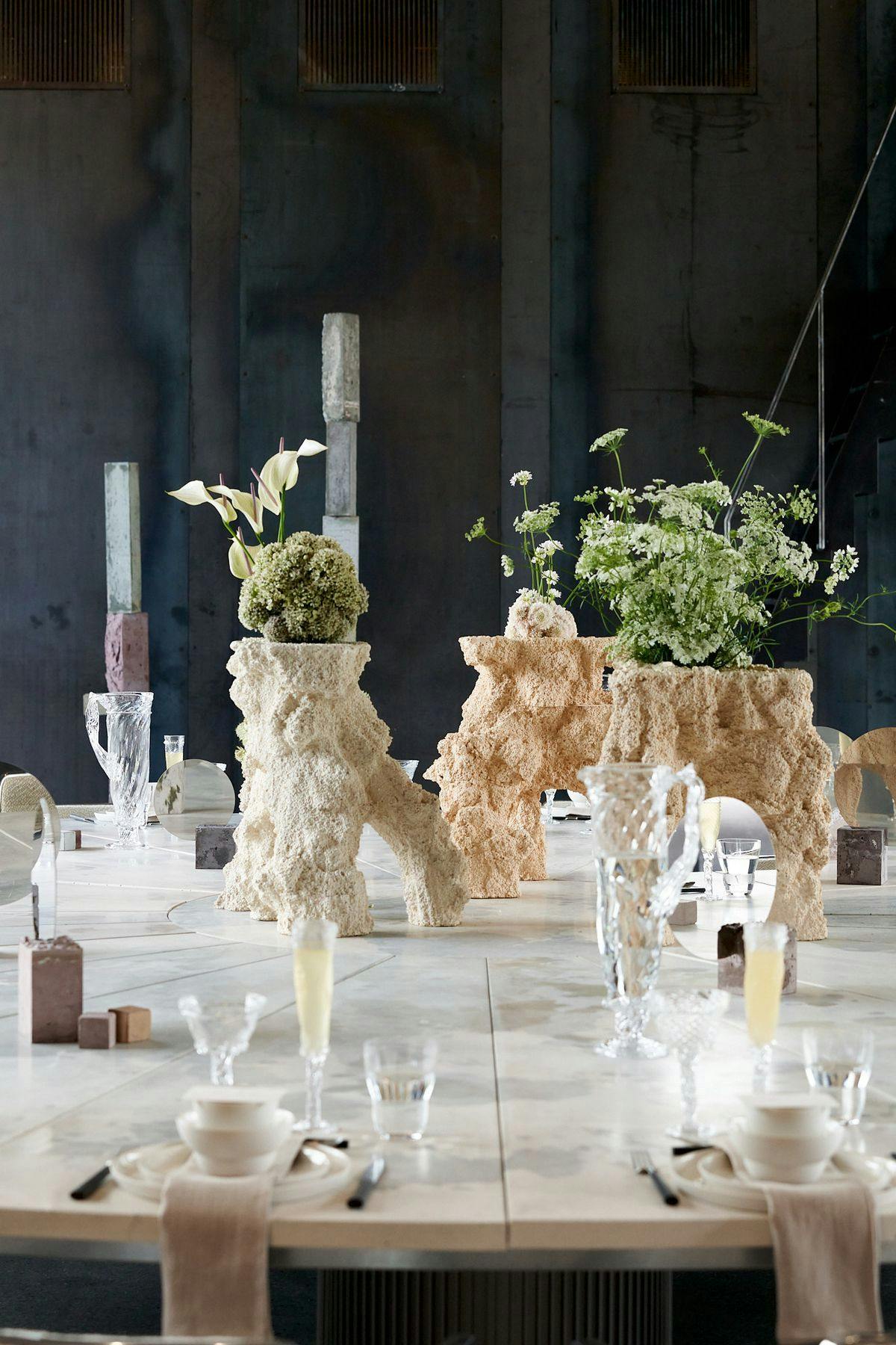 Close-up of table decor and setup for an event at Mogens Dahl Concert Hall. The image shows detailed decoration, including flowers and napkins, contributing to the elegant table setting.