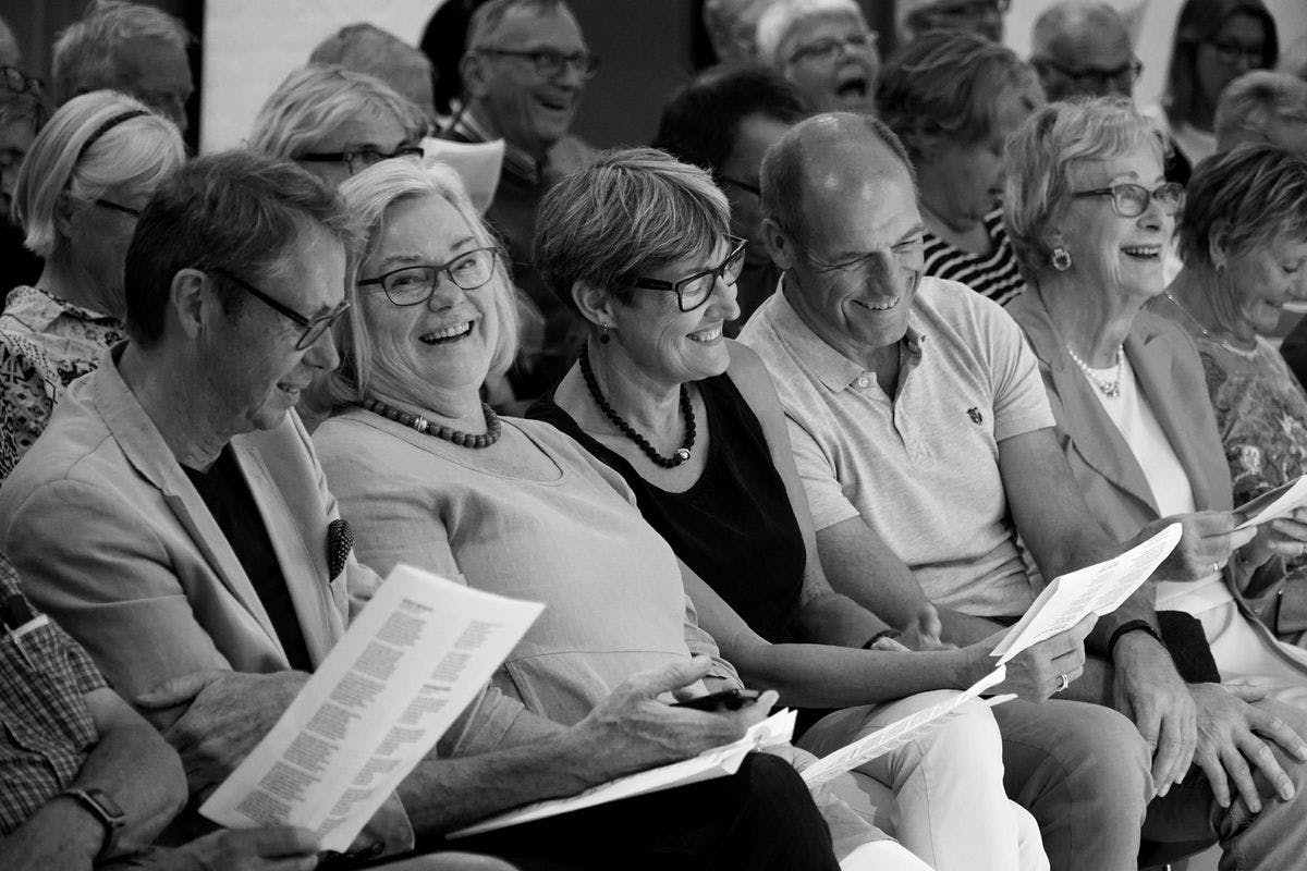 Black-and-white image of conference attendees seated in one of the flexible conference rooms at Mogens Dahl Concert Hall in Copenhagen.