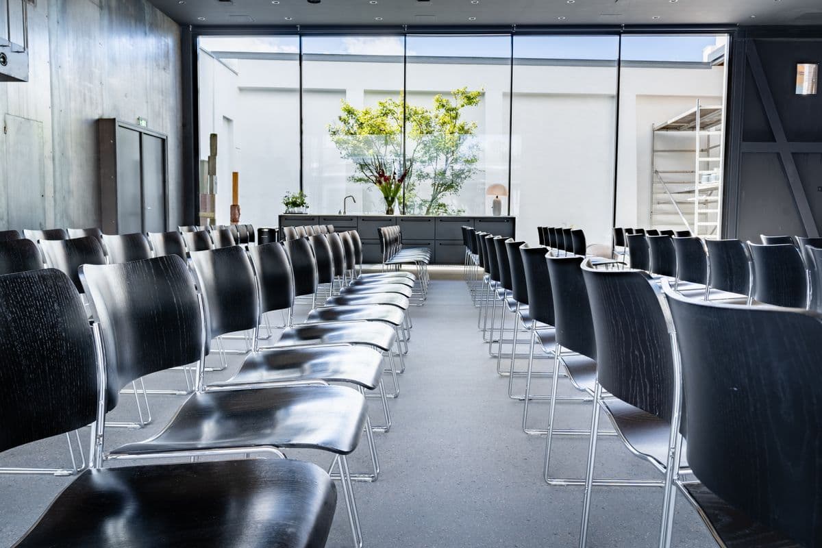 Image of chairs set up in the Garage at Mogens Dahl Concert Hall, ready for an event. The picture shows an organized seating arrangement prepared for the upcoming occasion.