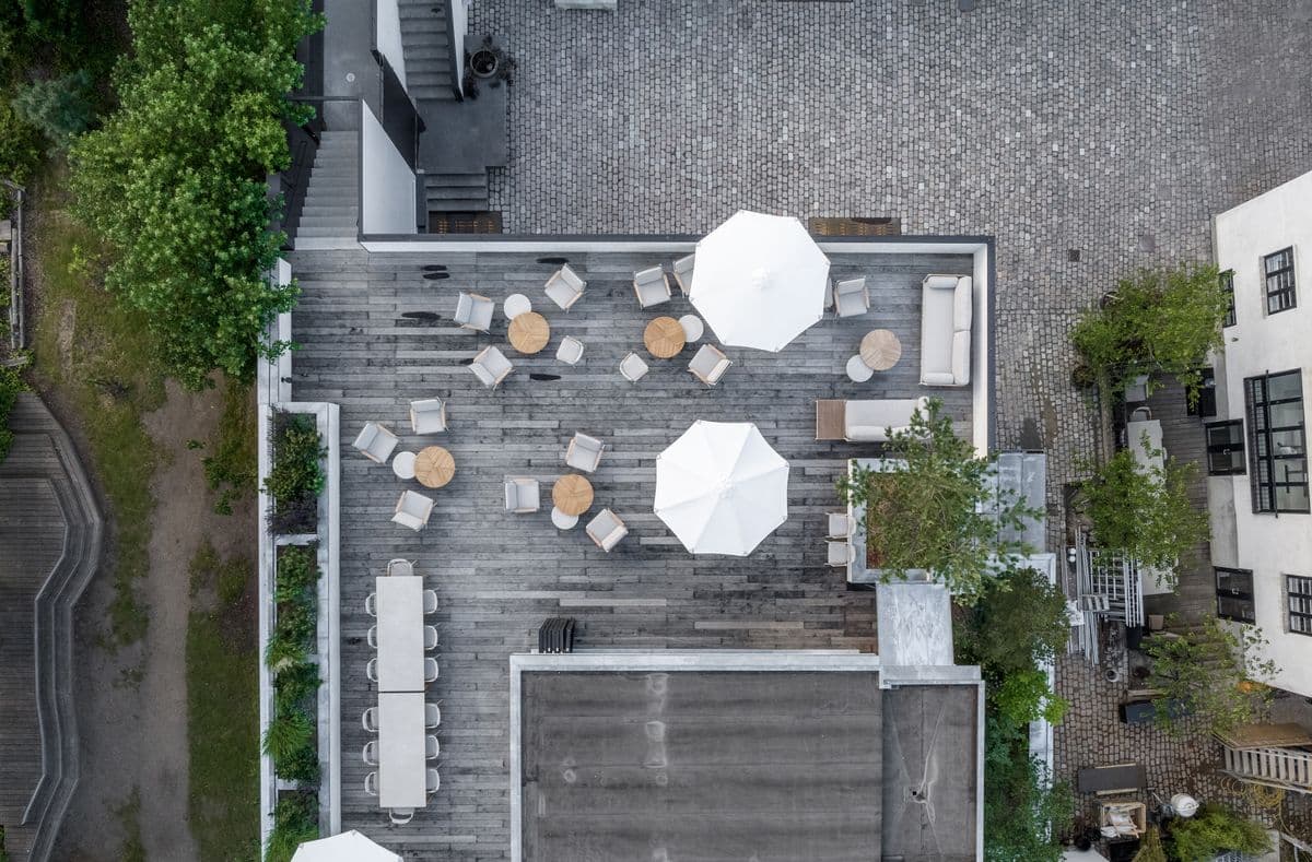 Overhead-billede af tagterrassen på Garagen ved Mogens Dahl Koncertsal. Billedet viser det udendørs område, der er forberedt til events med en klar udsigt over terrasseindretningen