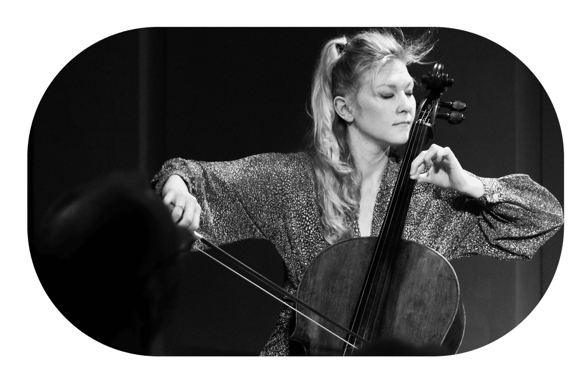 Black-and-white image of a person playing the cello, illustrating the musical quality and artistic excellence of concerts at Mogens Dahl Concert Hall. The picture supports a section about purchasing season passes so you don’t miss any musical experiences throughout the season.